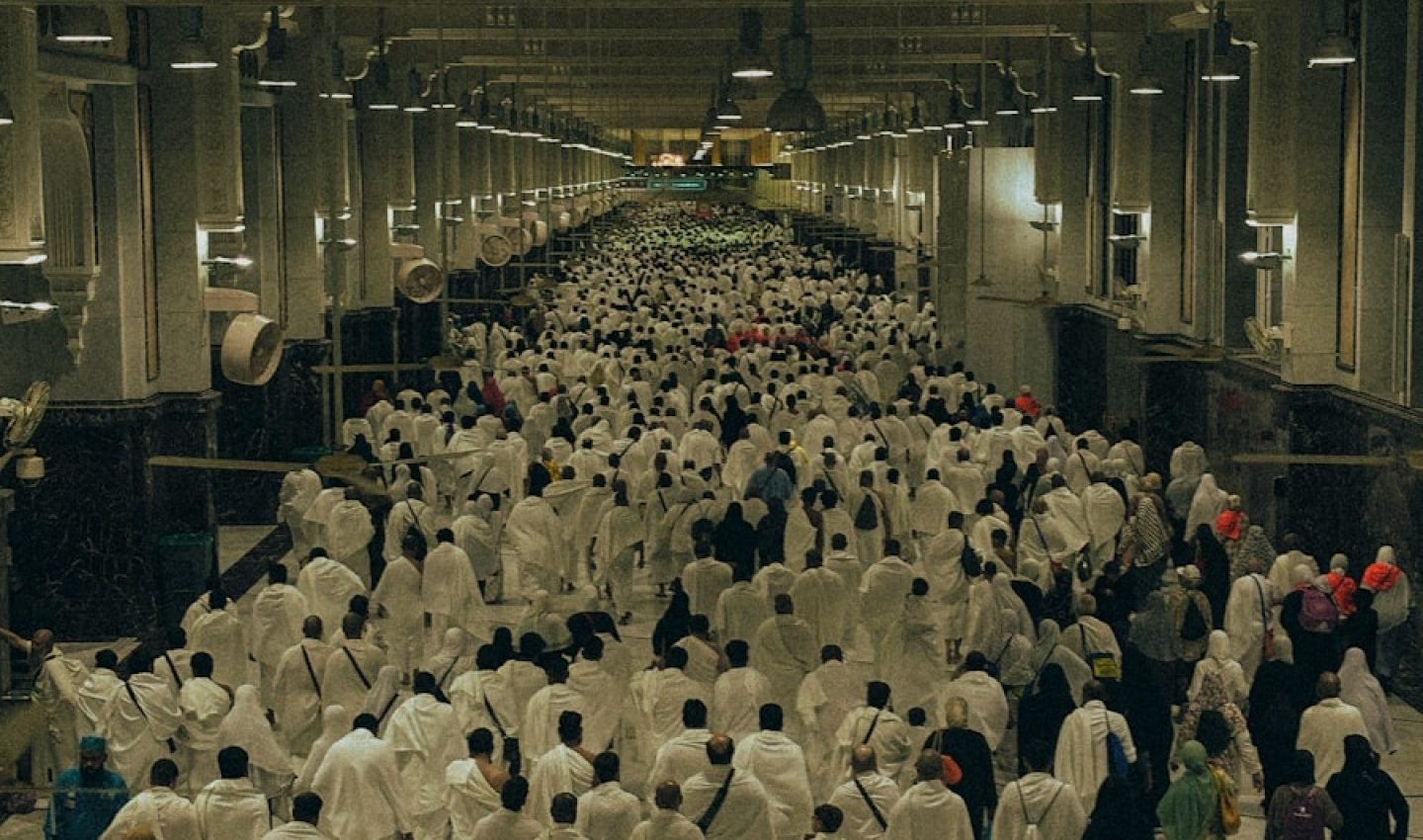 A large group of people walking down a hallway